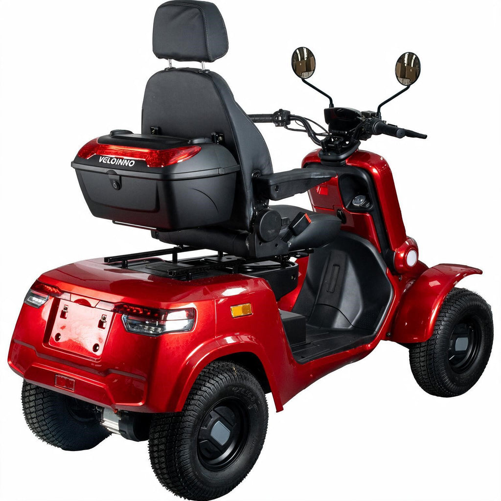 A red four-wheeled electric mobility scooter with a black seat, backrest, and storage box, shown from a three-quarter rear angle on a white background.