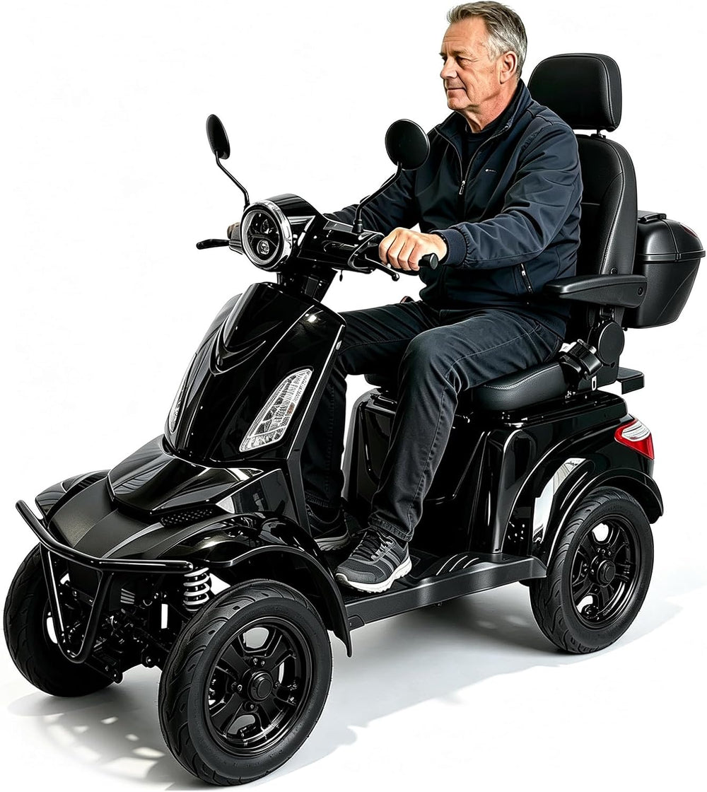 A man wearing a dark navy jacket and jeans is seated on a black four-wheel electric mobility scooter with a seat, headrest, side mirrors, and a storage box, photographed against a clean white studio background.