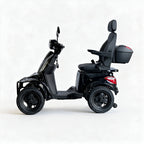 A black four-wheeled electric mobility scooter with a rear seat, backrest, and storage trunk, shown in a side profile on a light gray studio background.