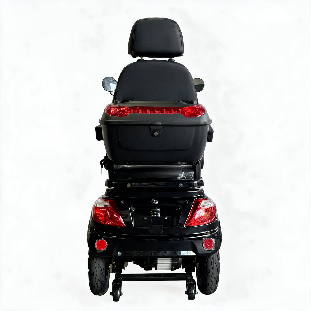 Rear view of a black electric wheelchair scooter with a large storage box, backrest, and red taillights on a white background.