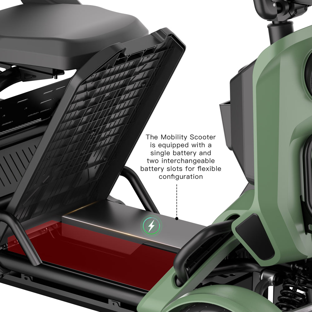 Close-up of a green and black mobility scooter showing the open storage compartment with a battery and text noting interchangeable battery slots.
