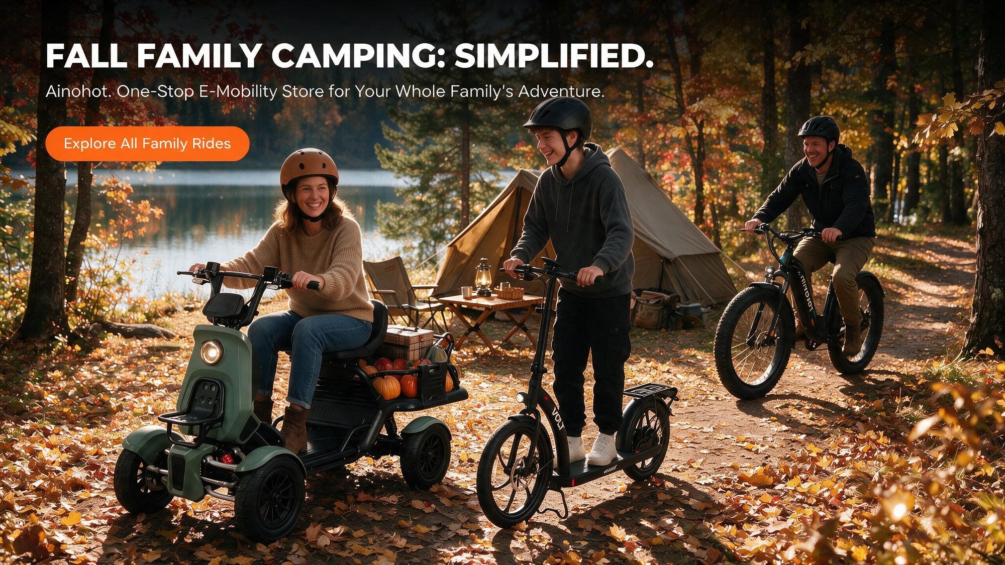 Three people camping outdoors in a wooded lakeside setting with autumn trees. One person rides an electric quad scooter carrying a cargo bed, while two others ride electric bicycles.